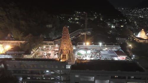 Vidéo aérienne du temple Kanaka Durga à Vijayawada la nuit. Le gopuram doré du temple, illuminé