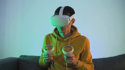 Man Using VR Headset with Controllers
