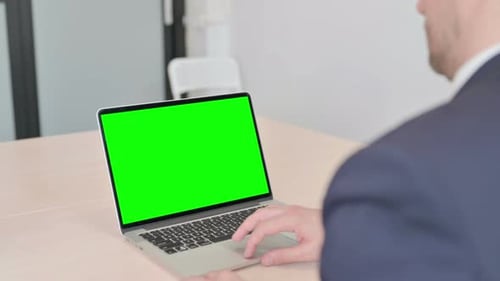 Businessman Working on Laptop with Green Screen