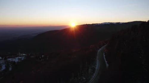 Aerial view of beautiful golden sunset over Dolomites mountain road. Italy
