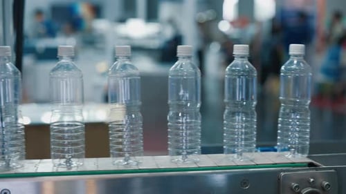 Production of Plastic Bottles Row of Empty Bottles on an Assembly Line in a Factory