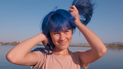 Smiling Woman with Blue Hair Plays with Pigtails