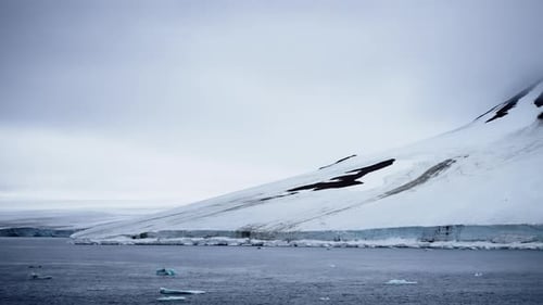Expansive View of Icy Wilderness Featuring a Vast Frozen Landscape Snowcovered Mountain Slopes