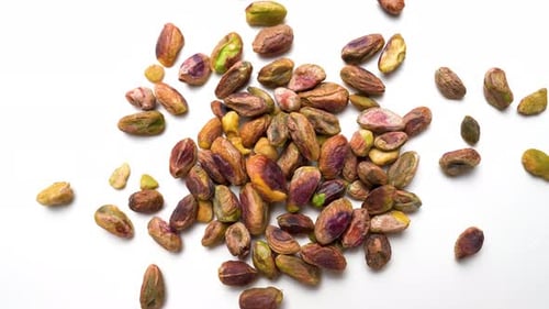 Pistachio Nuts Close Up Rotating View On White Table Background