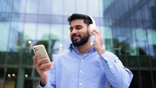 Man Listens to Music in Urban Setting