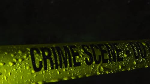 Crime Scene Tape Close Up in Rain at Night
