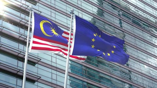 Malaysian and European Union Flags Waving in Corporate Setting