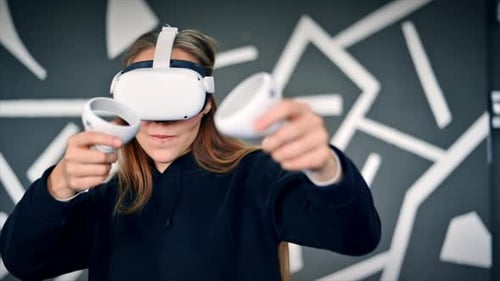 Woman Uses Virtual Reality Headset and Controllers Indoors