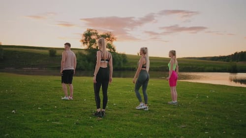 Group Fitness Practice in Park Three Blonde Woman are Squatting Training Muscles of Buttocks