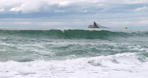 Fishing Boat In Wavy Sea