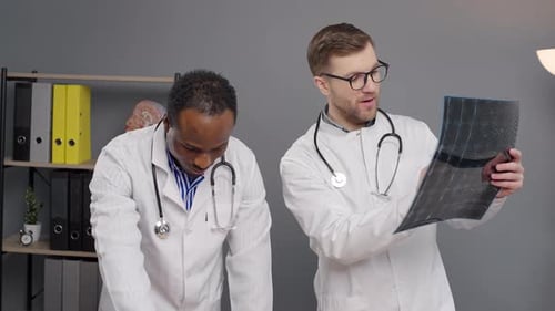 Doctors Reviewing Medical Scan in Office