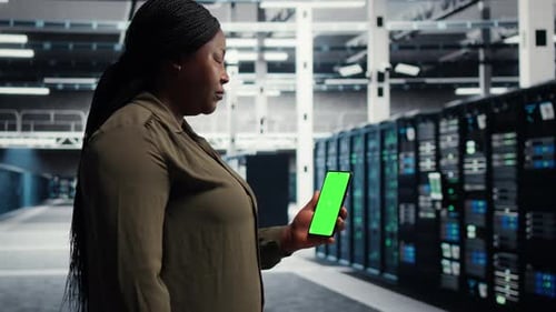 Data Center Programmer Runs Equipment Checkups Using Green Screen Laptop and Tablet
