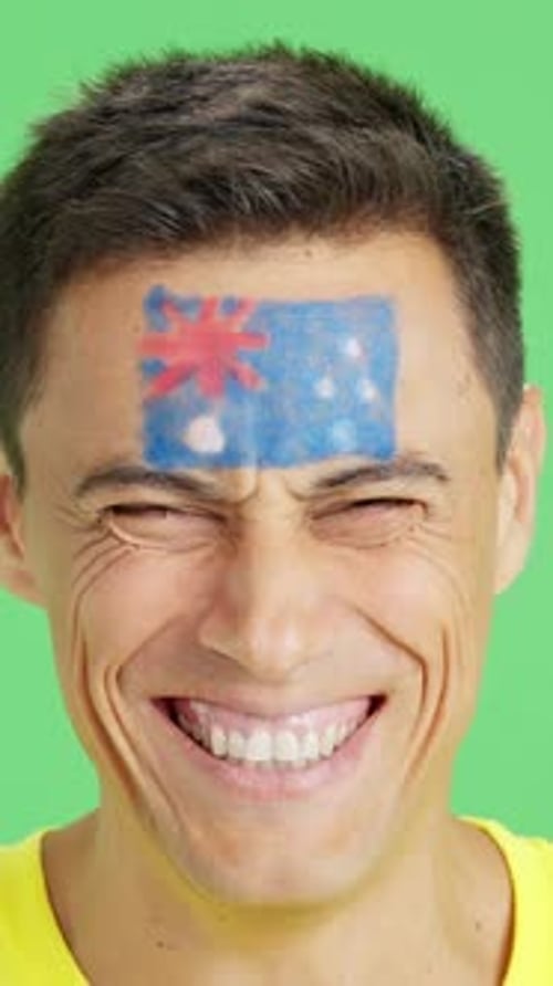 Smiling Man with Painted Flag on Forehead