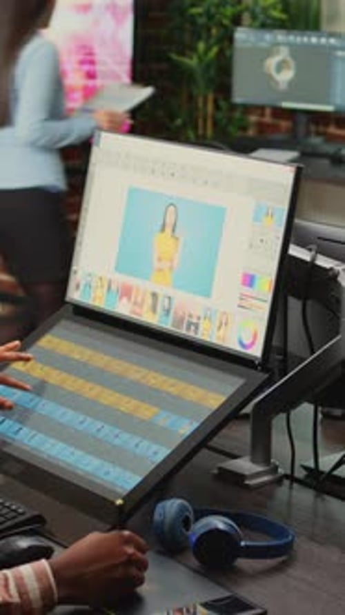 Digital Artist Editing Photos on High-Tech Workstation