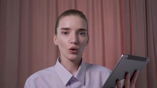 Young Woman Using Tablet Device for Video Call