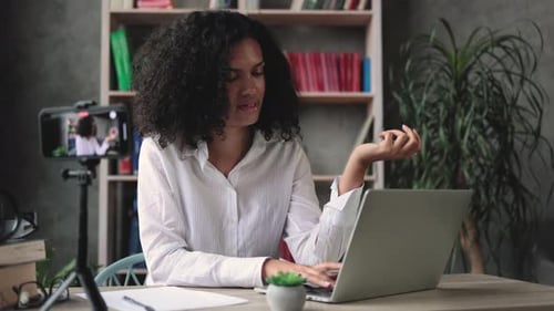 Woman Recording a Vlog on a Laptop Computer