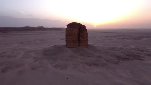 Lonely sandstone cliff in middle of desert in aerial orbit view