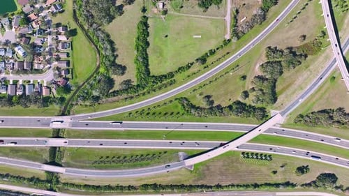 Aerial View of Freeway Overpass Junction with Fast Moving Traffic Cars and Trucks in American Rural