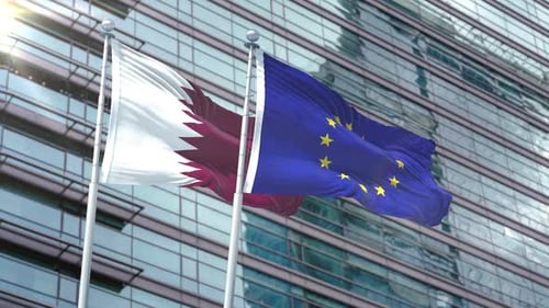 Qatar and European Union Flags Waving Against Corporate Building