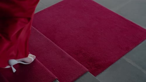 Elegant Woman in Red Dress Walking Down Stairs