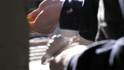 Person Cleaning Window with Yellow Squeegee