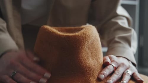 Woman Shaping Brown Felt Hat by Hand