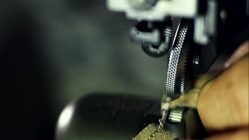 Artisan crafts leather with sewing machine in workshop close up of mechanism