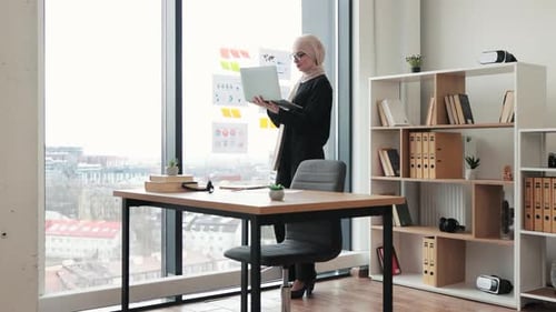 Woman With Laptop in Modern Bright Office