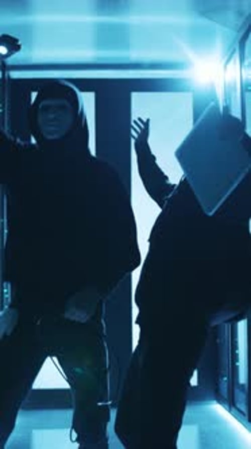 A Gripping Scene Featuring Thieves in Action Unraveling a HighTech Heist Scenario