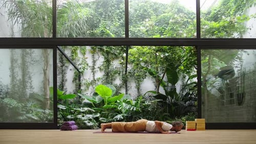 Man practicing leg lift in modern studio with graceful focus