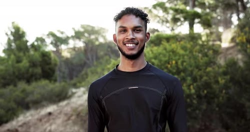 Young Man Smiling in a Sunny Outdoor Setting