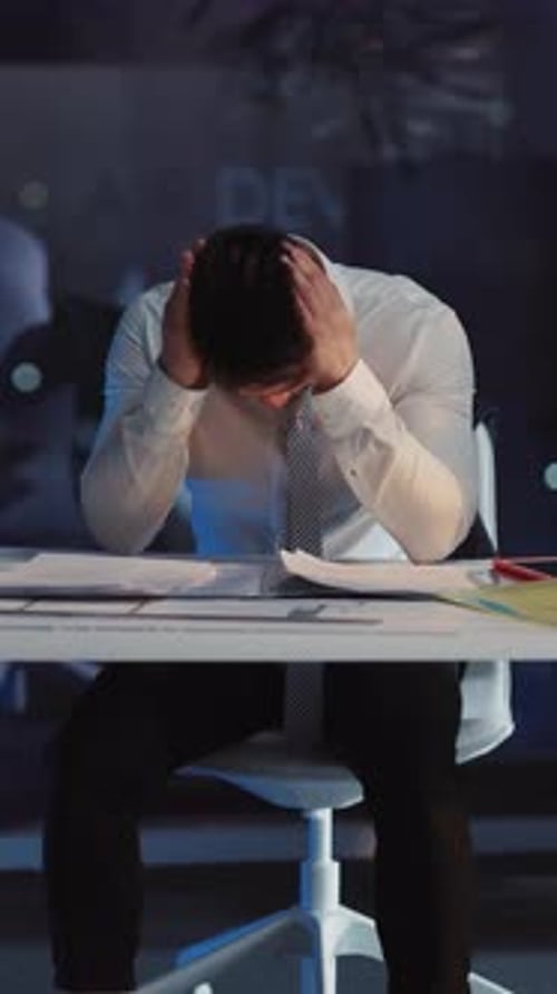 Stressed Man Working Late in Office