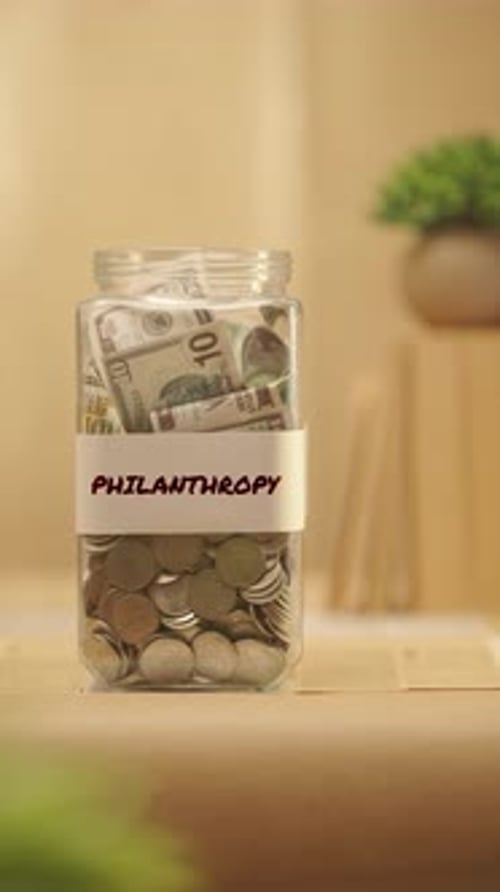 Contributing to Philanthropy Savings Jar With Money