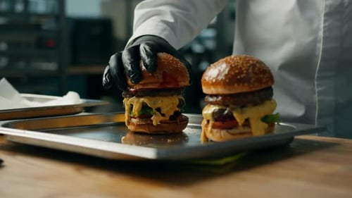 Gourmet Cheeseburgers Prepared in Restaurant Kitchen