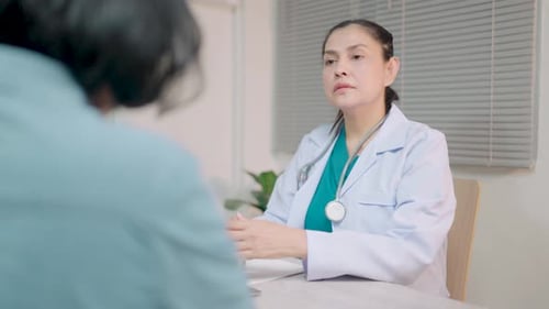 Doctor Consults With Patient in Office