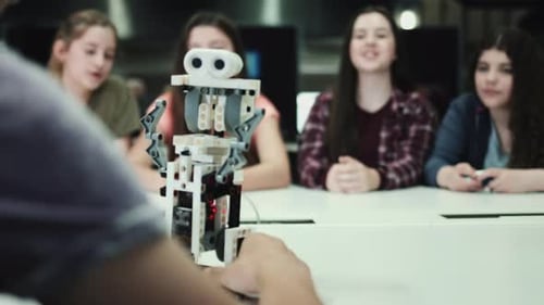 Five Children working with small robot at school