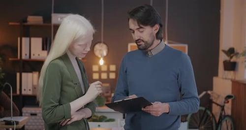 Businesspeople Colleagues Discussing Document Then Shaking Hands Enjoying Teamwork and Cooperation