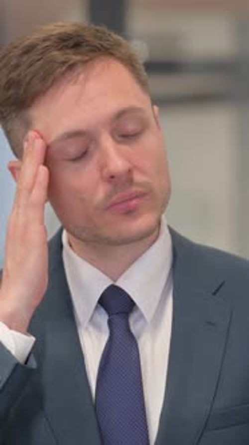 Man in Suit Experiencing Headache and Stress