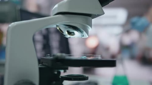 Doctor Hand Putting Sample to Microscope Using Medical Pipette in Lab Close Up