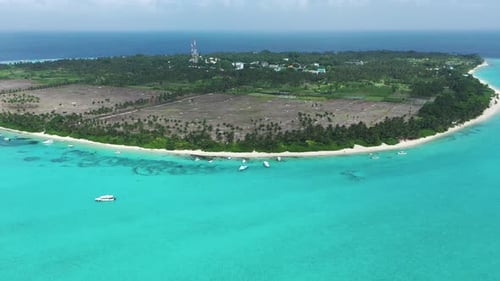 Aerial view of tropical island with turquoise water and beach, Maldives.