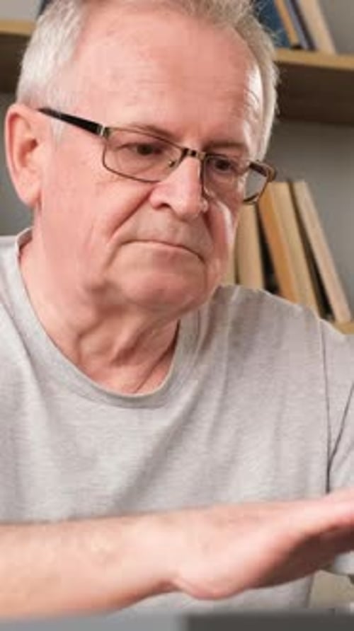 Senior Man Using Computer, Looking Stressed
