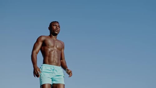 Muscular Man Exercising Outdoors on Sunny Day