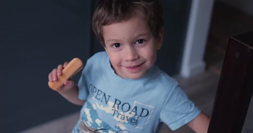 Cute Child Boy with Cookie in Hand Smile Look Straight to Camera