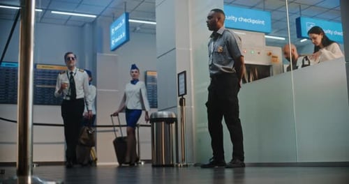 Flight Crew in Airport Terminal Airline Pilot and Two Flight Attendants Walking for Flight