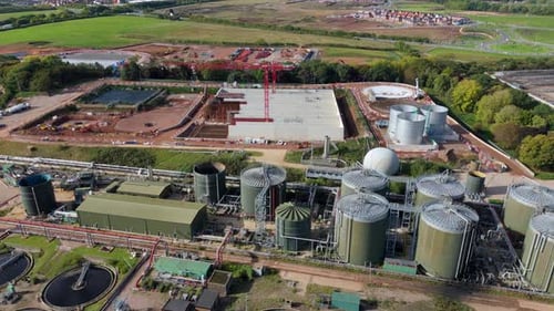 Drone footage of sewage processing infrastructure near Leicester, UK, with silos, tanks, and water