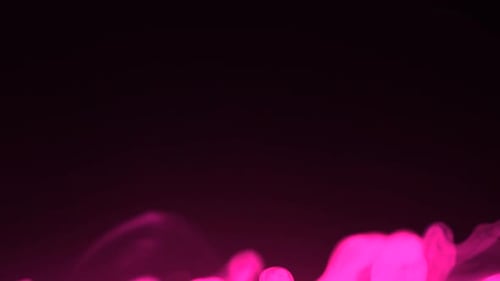 Pink Smoke Plume Floating Gracefully on a Deep Black Background Surface