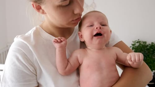 Infant being Held by Young Adult Indoors