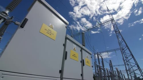 Capacitor Banks with Warning Signs By Towers at Substation