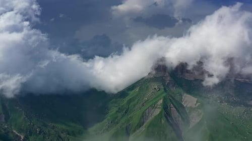 Green Mountain Peaks Encapsulated by Rolling Clouds