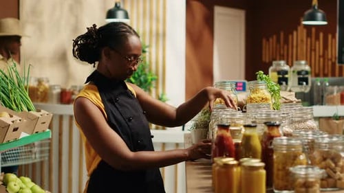 African American Vendor Arranging Bulk Products at Local Store